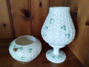 two pieces of Belleek porcelain with a green shamrock design